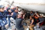 Rescuers pull six-year-old Suzy Eshkuntana, from the rubble of a building at the site of Israeli airstrikes in Gaza City on May 16, 2021. Photo: CNS/Mohammed Salem, Reuters