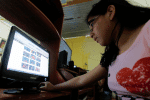 A depiction of a teenager looking at her Facebook page. Online child sexual abuse is a booming international business. Photo: CNS/Mariana Bazo, Reuters