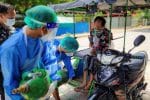 Volunteers help provide a Covid-19 patient with extra oxygen in Kale, Myanmar, on July 5. Photo: CNS/Reuters