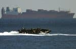 An Australian special forces team rides past the Norwegian freighter, Tampa, which was stranded off the coast of Christmas Island on 30 August 2001 with 430 asylum seekers aboard. File photo: CNS/Reuters