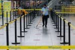 A worker wearing a protective mask and gloves mops the empty departure area at Ninoy Aquino International Airport in Manila, the Philippines. File photo: CNS/Eloisa Lopez, Reuters