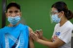 A man receives his first dose of a Covid-19 vaccine at a school in Manila, the Philippines, that is temporarily serving as a vaccination site. Photo: CNS/Lisa Marie David, Reuters