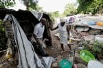 A couple walk through the collapsed remains of their home near Les Cayes, Haiti, on August 22. Photo: CNS/Henry Romero, Reuters