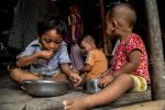 Children from a WFP beneficiary family having lunch at their home in an informal settlement in Hlaing Thar Yar Township, Yangon. Photo: UCAN/WFP
