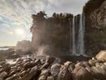 Jeongbangpokpo Falls, one of the top three waterfalls on Jeju Island. It is one of five or six waterfalls in Asia to fall directly into the ocean. Photo: Linda Yuan on Unsplash