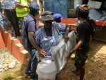 Earthquake victims receive hygiene kits and tarps from Catholic Relief Service workers in Les Cayes, Haiti, August 24. Photo: CNS/Godchild Regis, CRS