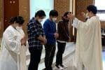 A priest imparts blessings on Filipino Catholics at a church in South Korea. Photo: UCAN courtesy of Moyse Cheonan