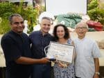 John Lewis and his wife receiving his first prize certificate from Father Ancheril and Father Tsui.