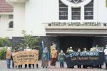 Members of Indonesian interreligious communities protest outside St. Theresa's Church in Jakarta on October 17. The left-hand banner reads: 'Teach children to love the environment' while the one on the right reads: 'Stop destroying nature which is the creation of God.' Photo: UCAN/GreenFaith International-Asia