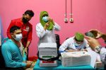 A man waits to get vaccinated with the AstraZeneca Covid-19 vaccine at the Dhaka Medical College vaccination center in Dhaka, Bangladesh. Photo: CNS/Reuters