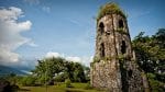 In the shadow of the volcano centuries old church tower stands tall