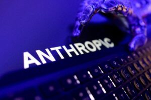 Blue crab resting on a laptop keyboard with the word 'ANTHROPO' visible on the screen in blue-purple light.
